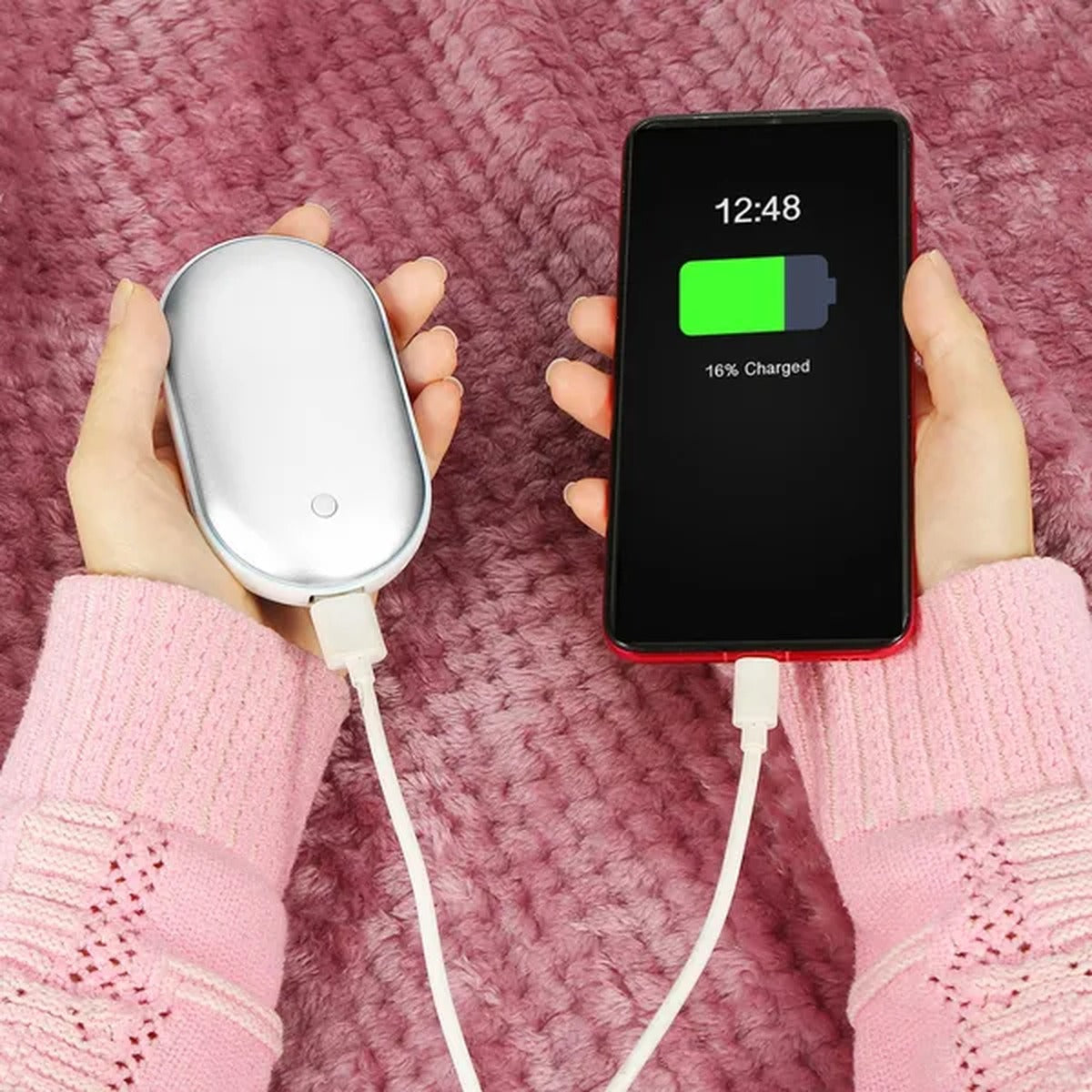 Hand warmer charging a phone as a power bank